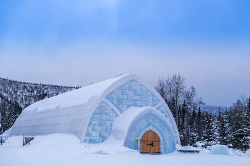 A snow igloo under a blue winter sky