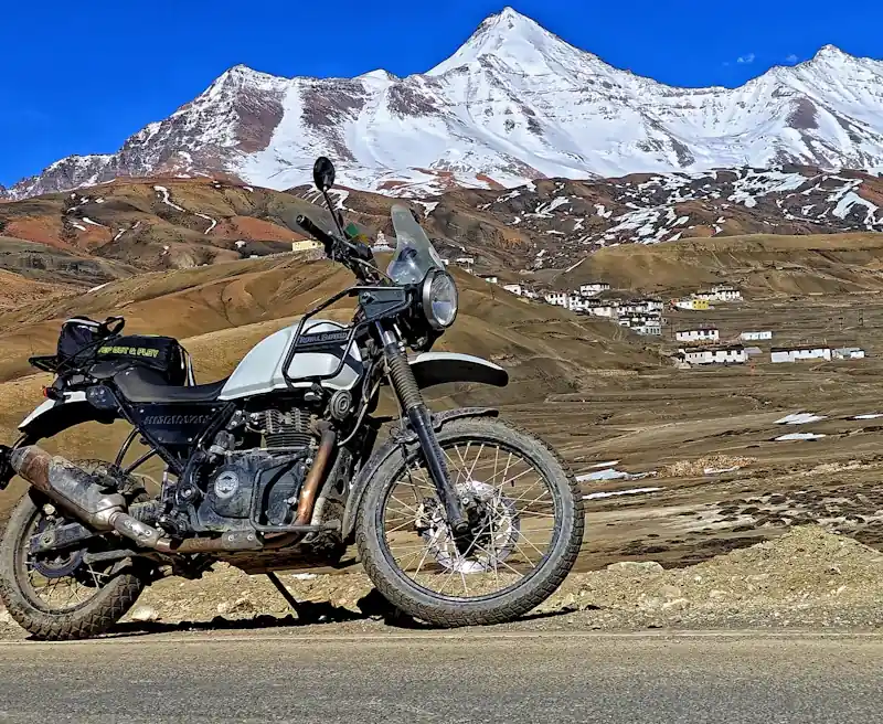 A loaded motorcycle on a mountain road.