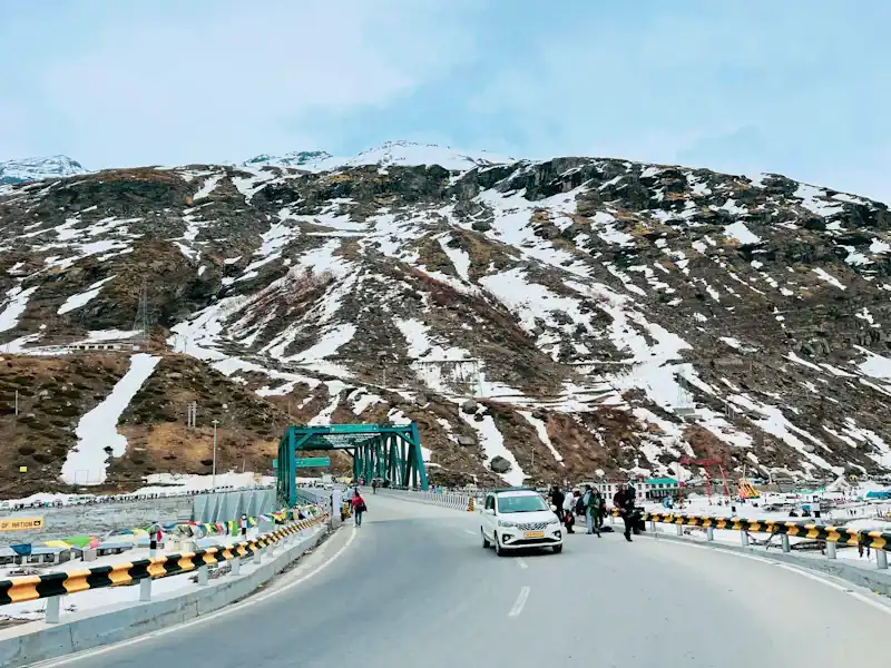 A road through the mountains seen from a car.